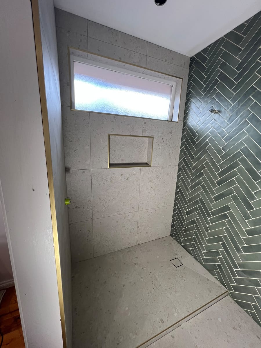 Architectural walk-in shower with clean epoxy grout joints